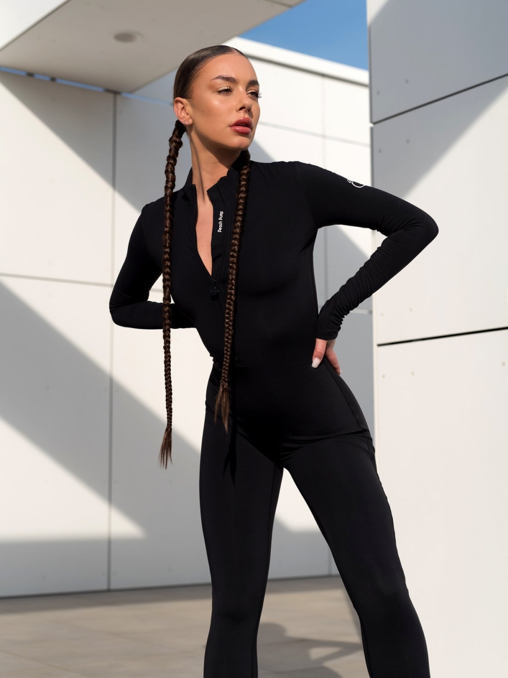 Peach Pump black bodycon jumpsuit with front zipper and hidden white lettering