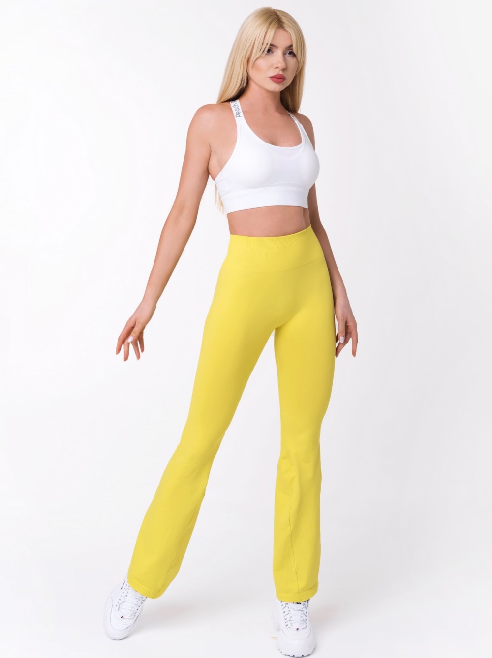 Damskie, sportowe legginsy z wysokim stanem w kolorze żółtym z szerokimi nogawkami