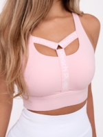 Ženski sportski grudnjak u ružičastoj boji s natpisom Peach Pump na prednjoj strani