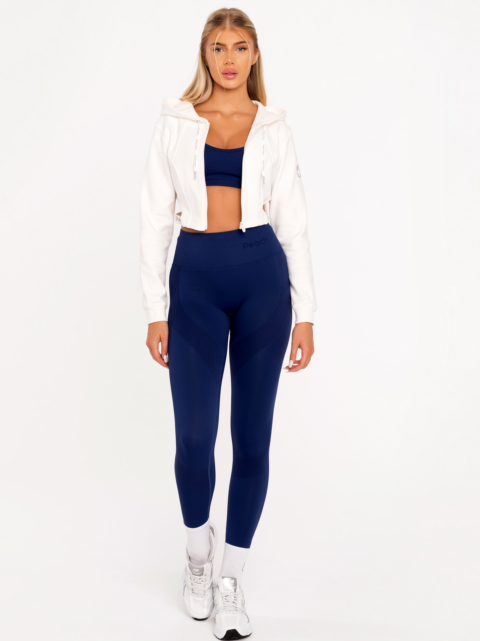 Къс бял суичър с преден цип, голяма качулка и изрязани детайли на талията